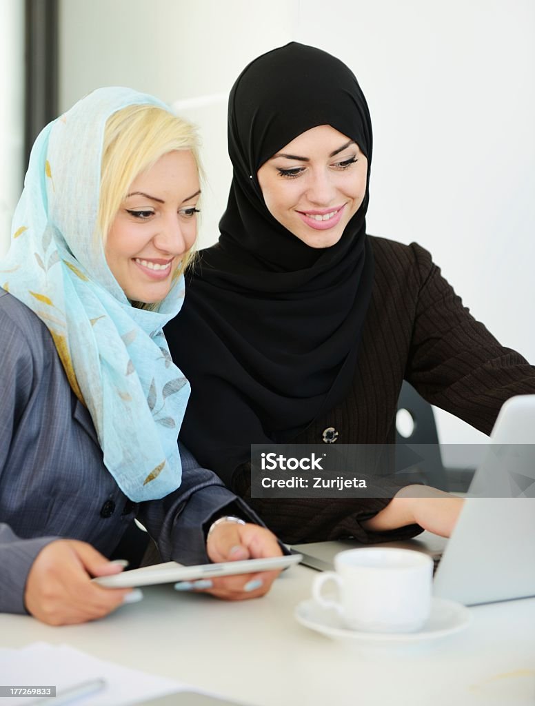 Two women having a business meeting in an office Group of Muslim women working Adult Stock Photo