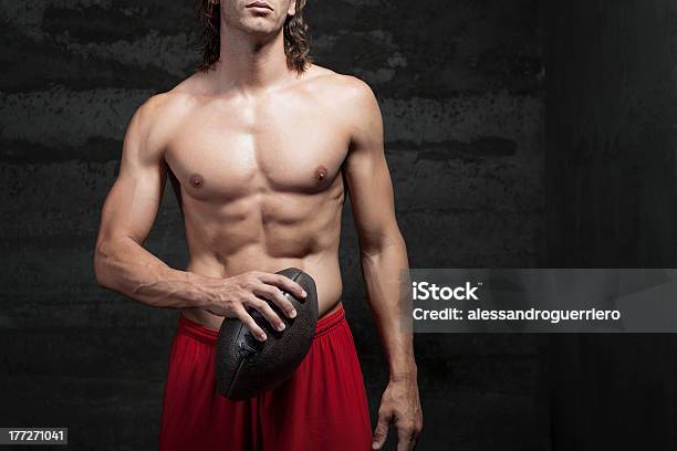 Bare Chested Muscle Man Is Holding Football Ball In Hand Stock Photo - Download Image Now
