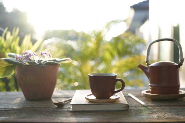 istock Brown tea cup and tea pot with brown plant pot and notebooks 1772714196