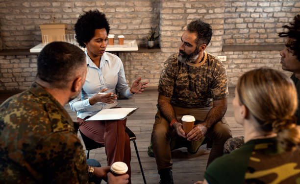 istock Group of diverse veterans talking during PTSD support group. 1772718572