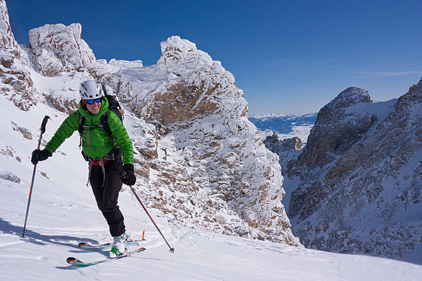 Teenage girl, women snow skier skiing, enjoying on ski resorts. Skiing carving at high speed. Lightweight fresh snow in the foreground, beautiful white powder snow in the background. Shot with Canon 5DMarkIII, developed from RAW, Adobe RGB color profile. Shallow DOF for soft background.