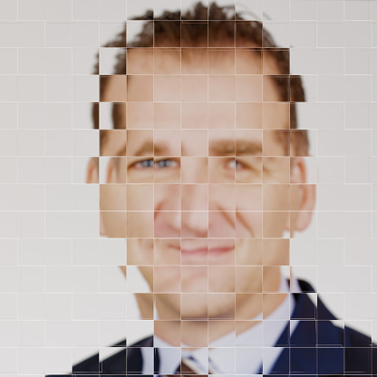 Broken image (portrait), diffracted through pixelated glass, of a businessman, blond and curly, that becomes an avatar. Collage CGI / photo