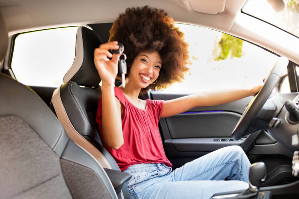 istock Cheerful black female showing key in automobile 1772720341