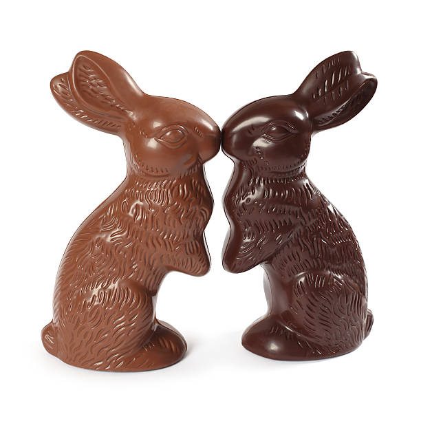 Chocolate Easter bunnies kissing "Photo of two chocolate Easter bunnies kissing, one milk chocolate and one dark chocolate. Clipping Path included." chocolate bunny stock pictures, royalty-free photos & images