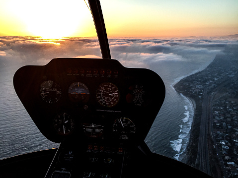 Aerial view from a helicopter of a Southern California marine layer sunset along the San Diego County coastline.