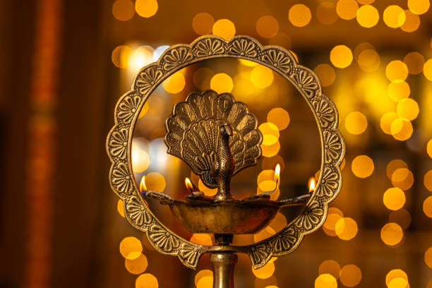 Diya lamp stand in Diwali illuminated light in background