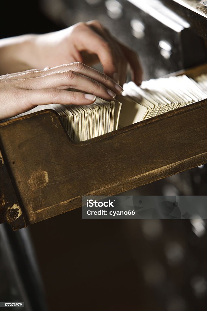 Searching in archives. Searching in archives. Student hands searching from a filling cabinet. Alphabetical Order Stock Photo