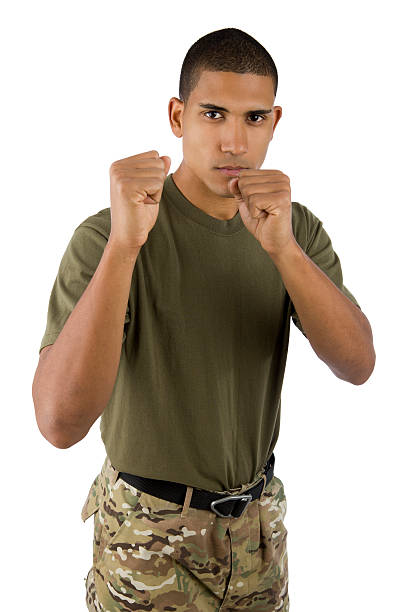 A black soldier stands with his fists up