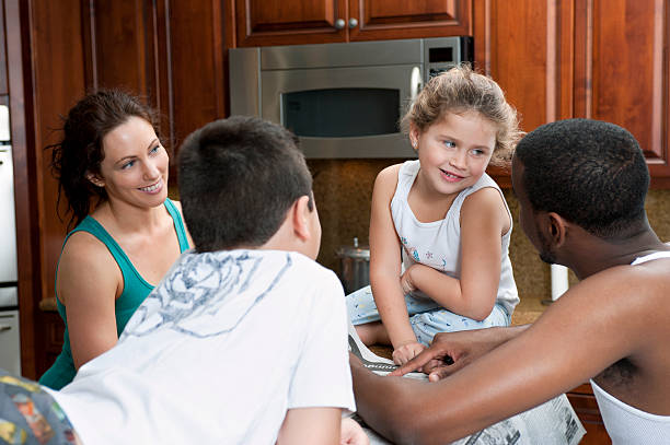 Multi ethnic family sharing in the kitchen stock photo