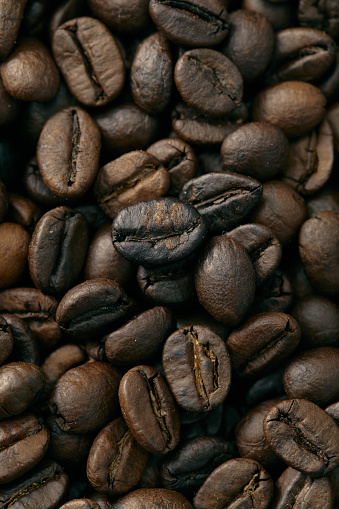 Roasted coffee beans falling o white background
