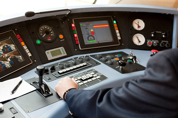 Person wearing blazer with left hand on railroad dashboard stock photo
