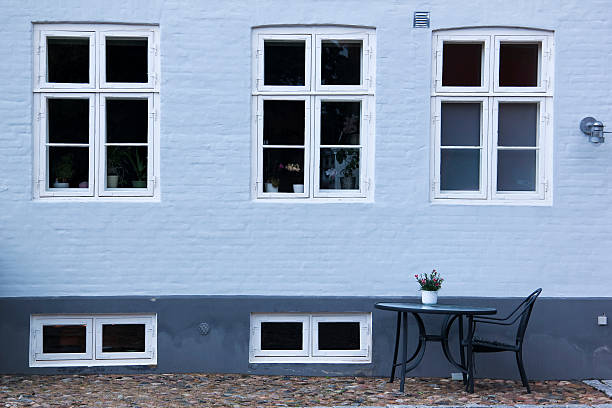 table and chair sitting on cobbled street outside pavement cafe in ebeltoft denmark