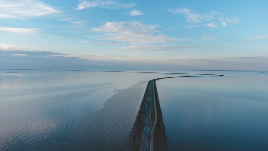 Aerial view of the man-made road through the North Sea to another part of the Northern Netherlands. Unique transport construction.