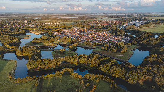 Aerial view of the historic town of Naarden and its star-shaped canals during sunrise. Dutch history.