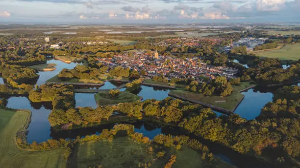 Photo of Aerial view of the historic town of Naarden and its star-shaped canals during sunrise. Dutch history