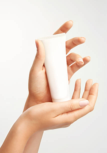 Woman's hands with care cream tube stock photo