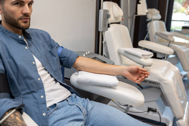 istock Man preparing for insertion of drip in clinic. 1772781324