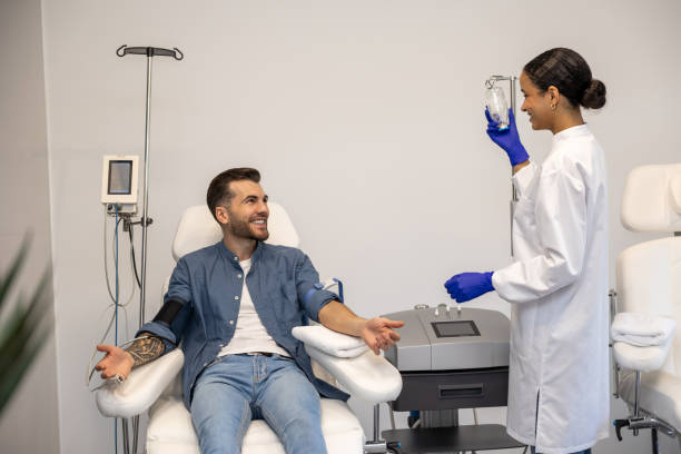 istock Smiling man doing insertion of drip in clinic. 1772781351