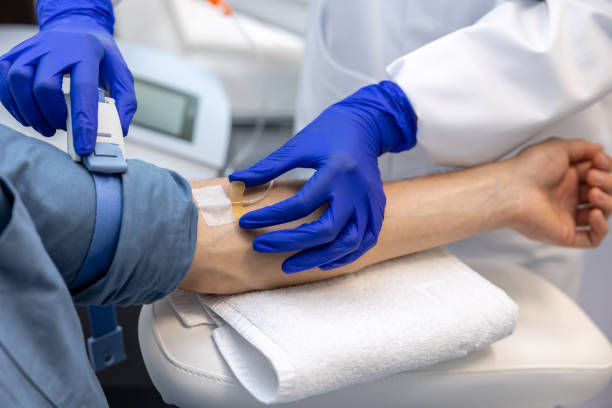 istock Inserting catheter into vein in patient's arm in hospital medicinal solution intravenously. 1772781377