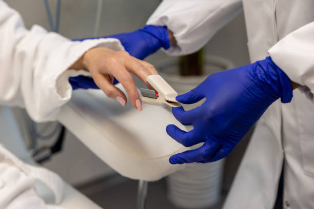 istock Unknown nurse checking oxygen level through oximeter to female patient. 1772781387