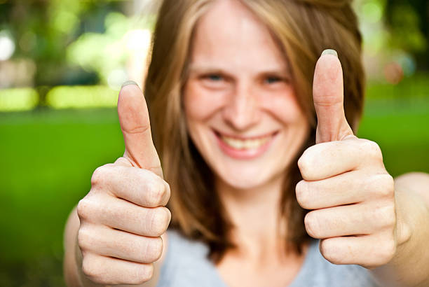 istock woman showing thumbs up 177280438