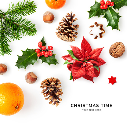 Red poinsettia, holly, fir branch, cone, nut, cookie and orange border isolated on white background. Christmas time decoration. Creative layout. Flat lay, top view. Design element
