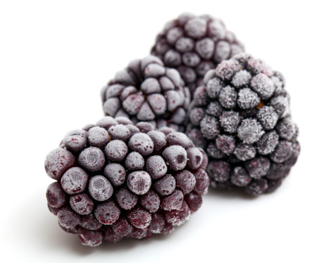 frozen blackberries isolated on white background