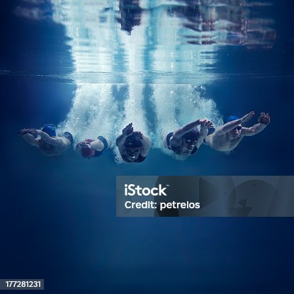 istock Five swimmers jumping together into water, underwater view 177281231