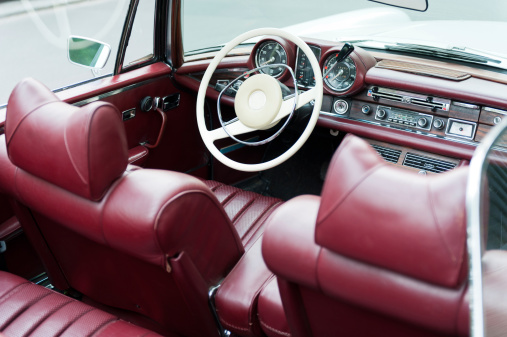 Interior of an old cabriolet with red leather seats