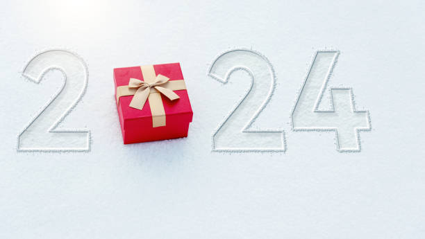 istock New year number 2024 written on snowfield with gift 1772817324