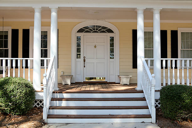 Front porch steps of house with columns, veranda front porch on yellow home with white columns, steps leading up to door with white door and brass kickplate, taken with Canon 5D Mark II digital camera house railing stock pictures, royalty-free photos & images