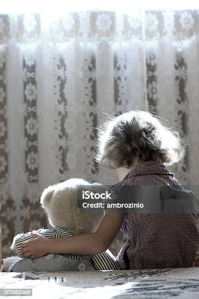 A Sad Little Girl Cuddles Her Teddy Bear Stock Photo - Download Image Now - Shock, Child Abuse, Childhood