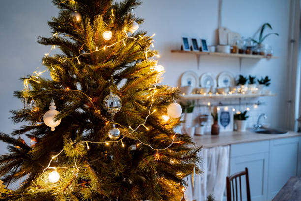istock Christmas lights in the interior, Christmas tree with a garland, selective focus, blurred background, evening shooting, holiday atmosphere, picture with noise 1772835672