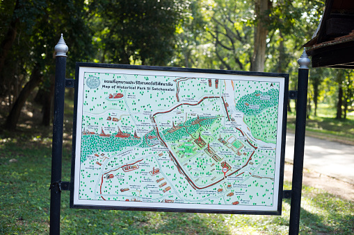 Map of Sukothai ancient history park in Phitsanulok province. Around several temples is a fortress wall with gates. Location of map is at Ramnarong gate