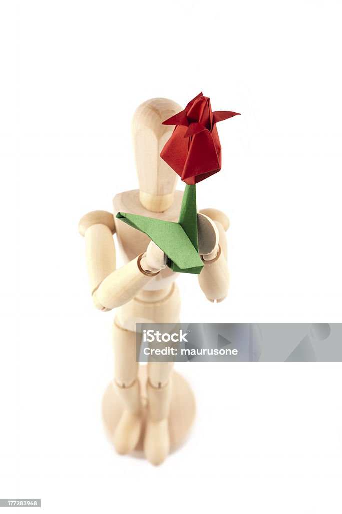 Mannequin and red flower Greetings. Wooden mannequin giving handmade paper flower Birthday Stock Photo