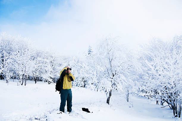 istock Man photographing a beautiful winter landscape 177283997