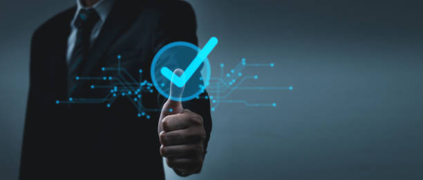 istock Quality Assurance. business man hand thumb up and touching virtual blue correct sign on dark background, quality control, business finance, guarantee, cybersecurity, digital technology concept 1772840890