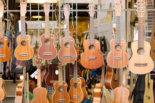 Hanging classic guitars at store on JJ Weekend Market in Bangkok Chatuchak, largest and  most popular outdoor market in Bangkok