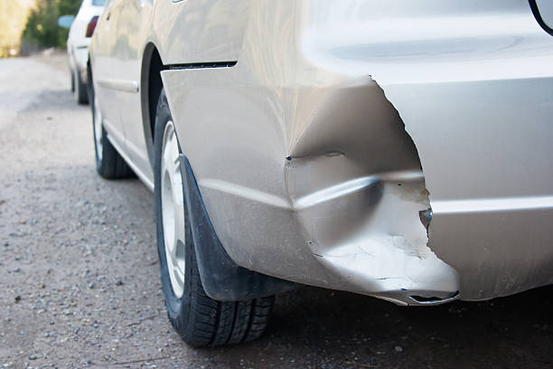 Damage Damage on the rear bumper of a car after a car accident. bumper stock pictures, royalty-free photos & images