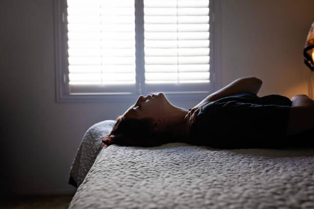 istock Woman laying on bed hugging herself 1772866768