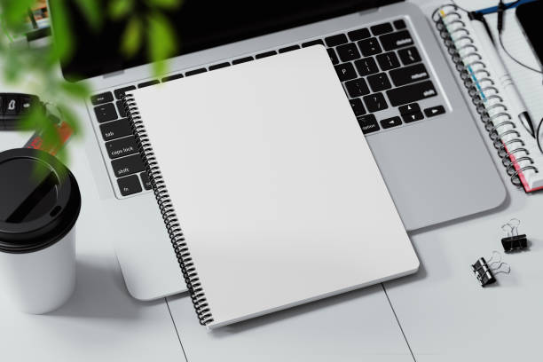 istock Coil bound book on a laptop keyboard mockup. 3D rendering 1772867881