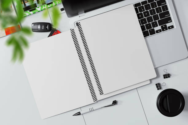 istock Two coil bound books on a laptop keyboard mockup. 3D rendering 1772870265