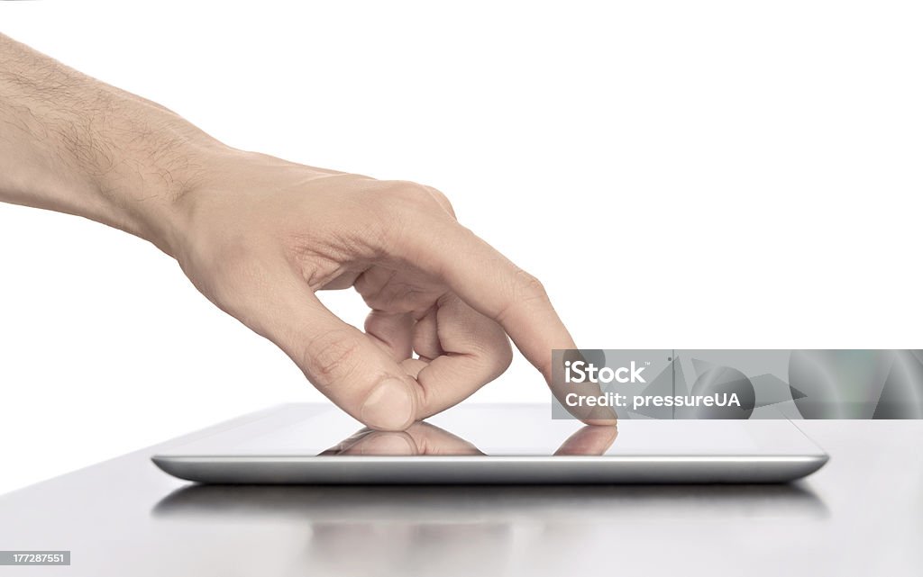 Working With Digital Tablet PC Man hand touching screen on modern digital tablet pc. Close-up image with shallow depth of field focus on finger. Isolated white background. Communication Stock Photo