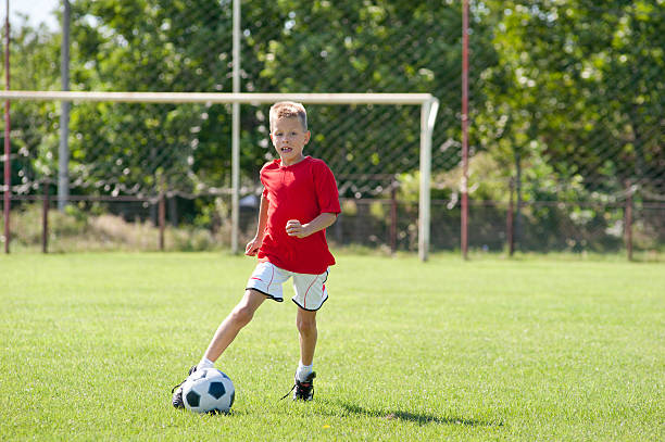 istock Child playing soccer ball 177287910