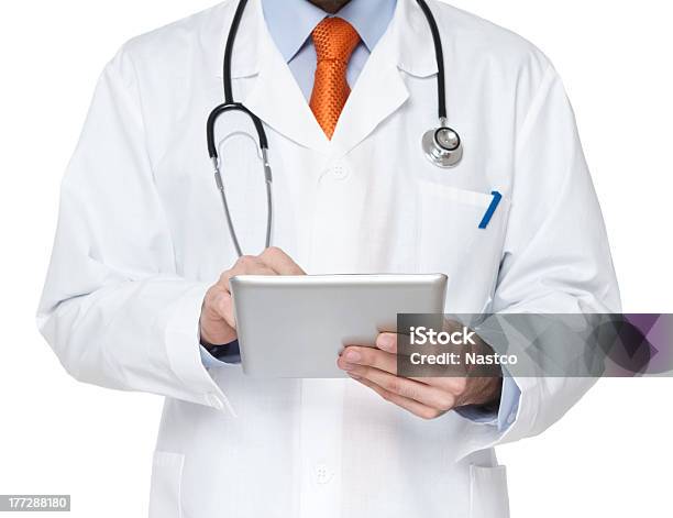 Doctor Working On A Digital Tablet Stock Photo - Download Image Now - Necktie, Orange Color, Adult