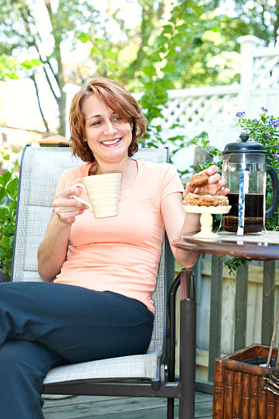 istock Woman in backyard with coffee and cookies 177288243