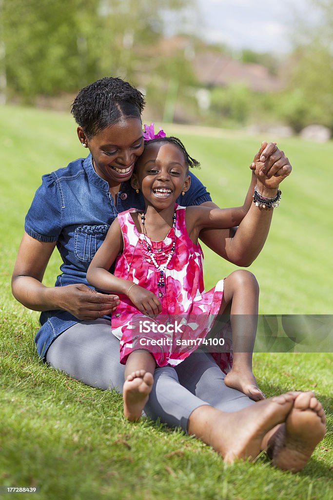 Adorable african mother with her daughter in the garden Portrait of a adorable african mother with her daughter in the garden Child Stock Photo