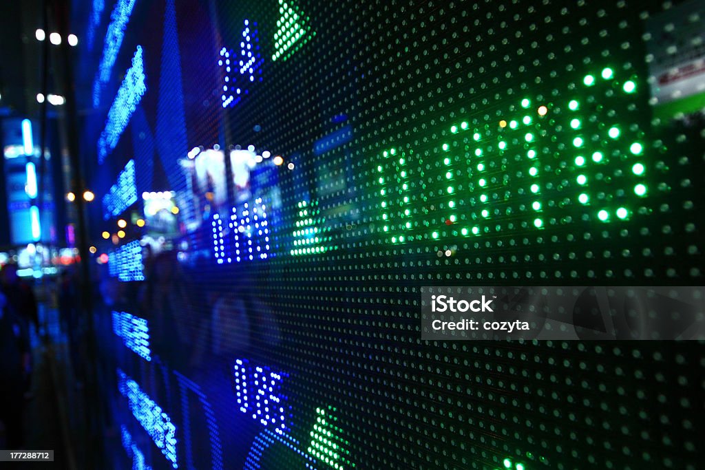Ticker board displaying finance data in neon colors Colored ticker board at outdoor Wall Street - Lower Manhattan Stock Photo