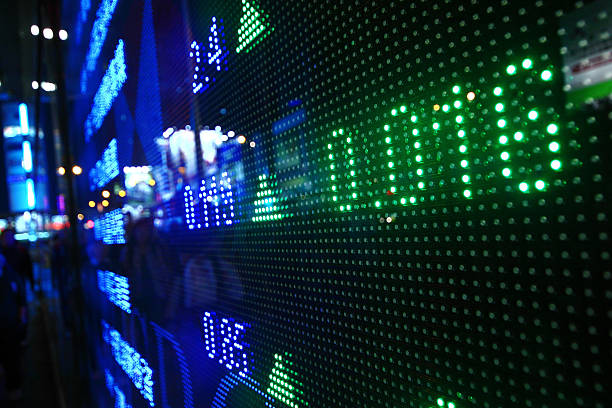 Ticker board displaying finance data in neon colors stock photo