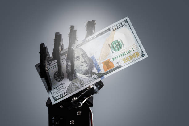 istock Robotic hand holding hundred dollar bill. Investment in Artificial Intelligence technology and job replacement by AI 1772887970